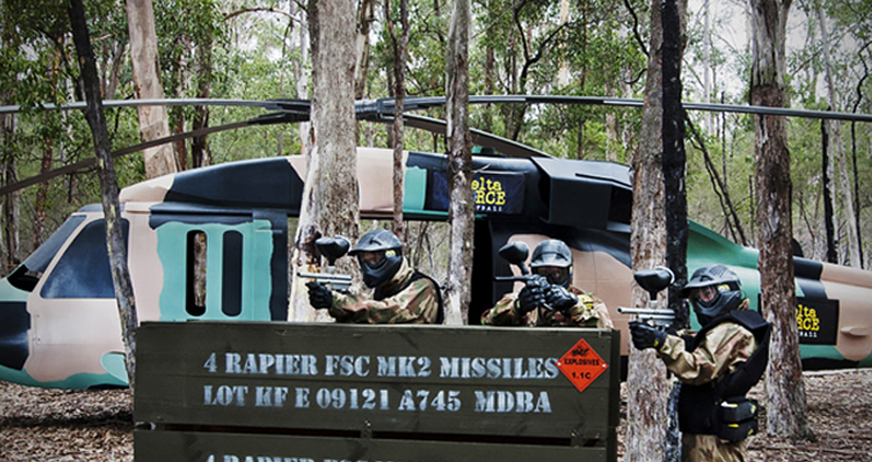 Players in a helicopter-inspired paintball arena